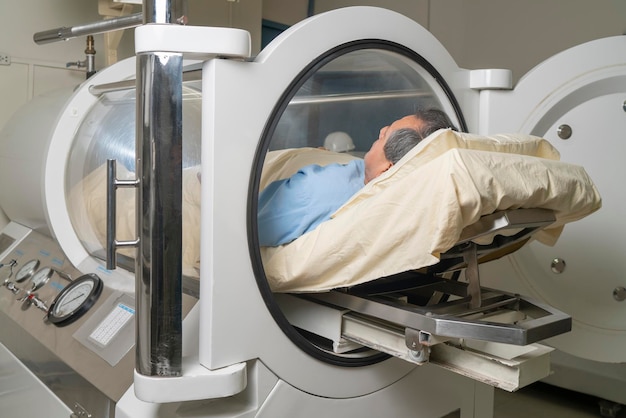 Man inside a machine for hyperbaric treatment