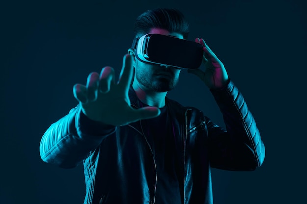 Man interacting with virtual reality under neon illumination