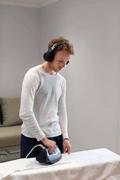 Man ironing shirt medium shot