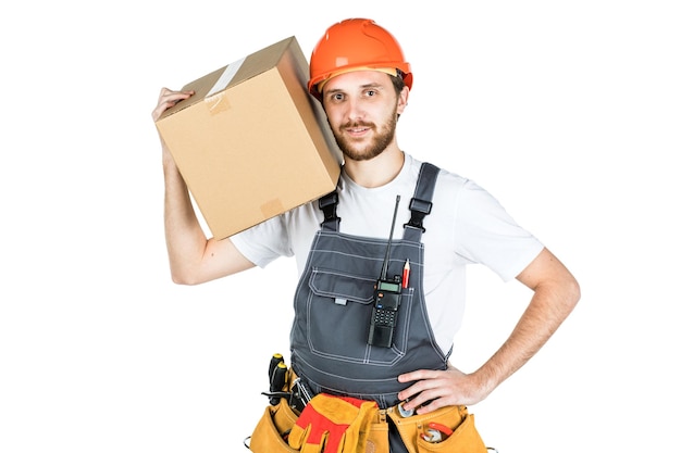 A man is a builder with a cardboard box in his hands Isolated over white background