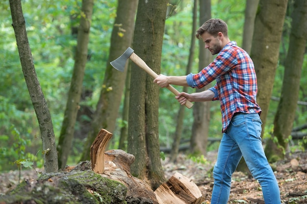 Photo man is chopping wood with vintage axe, picnic.