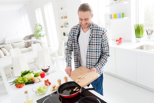 man is cooking in modern kitchen