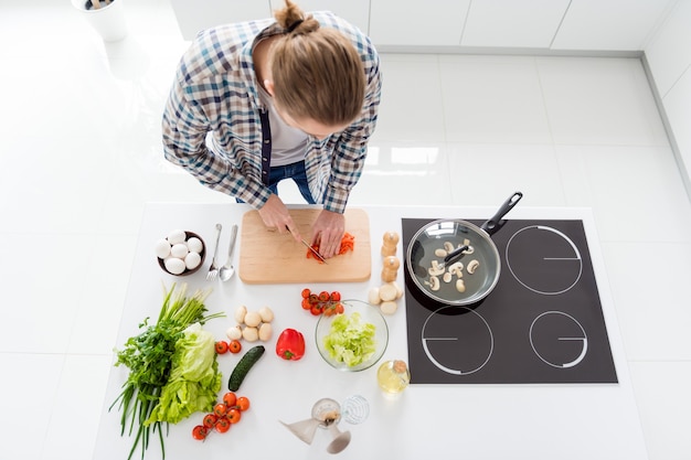 man is cooking in modern kitchen