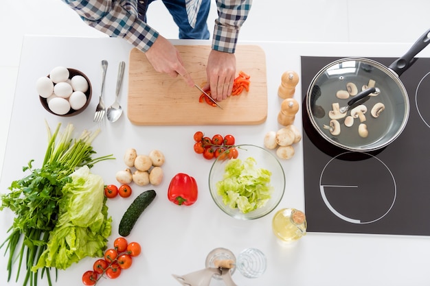 man is cooking in modern kitchen