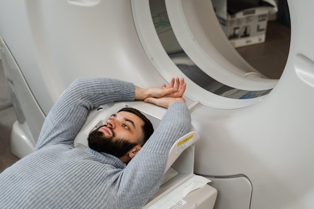 Man is doing computed tomography xray examination of abdominal in a CT scan room CT scan of abdominal of man in medical clinic