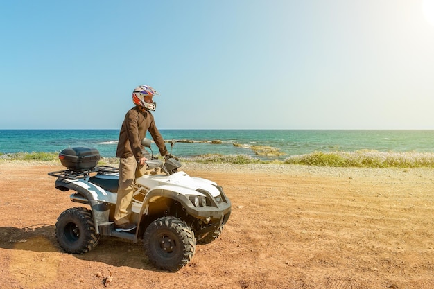 A man is driving ATV on offroad Sunny