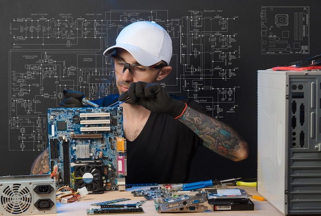 Man is engaged in repair of computers