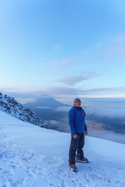 Man is feeling freedom in the top of the mountain