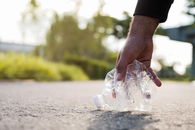 A man is helping to collect plastic bottles in the streets to
keep the streets clean and to separate plastic waste.