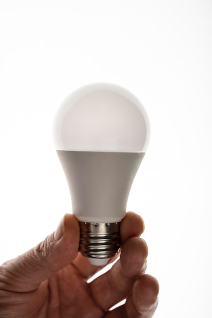 A man is holding an LED light bulb. Energy saving LED bulb.