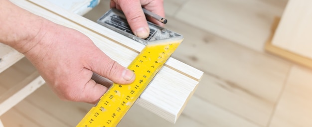 Man is installing the doors. Ruler in hands. Repair works. Maintenance in the apartment.