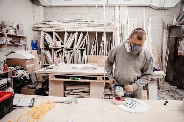 The man is involved in the process of selection processing and assembly of wooden blanks