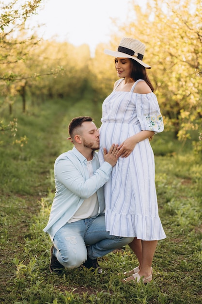 Man is kissing pregnancy belly of his wife