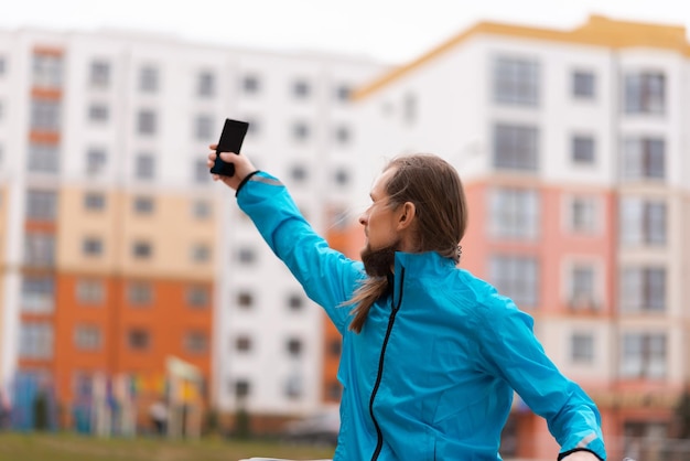 A man is looking for a mobile network between buildings