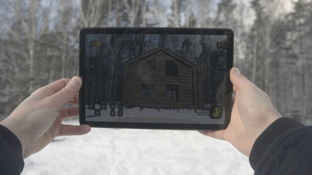 Man is making architecture photography with tablet in winter home and building concept