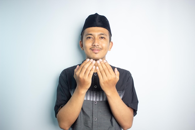 A man is making a hand gesture with the word eid on the front.