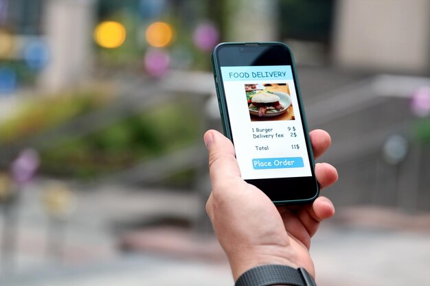 man is ordering food on the internet using an app in the downtown