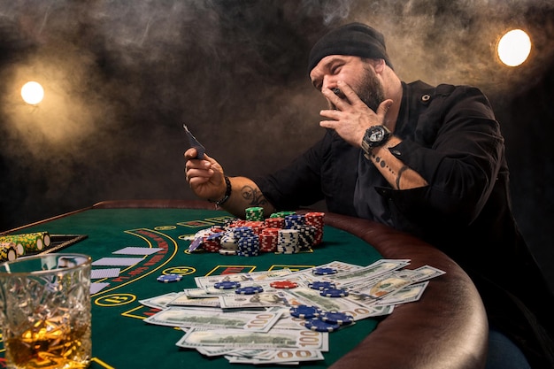 Man is playing poker. emotional fail in game, game over for\
card player, man very angry with foolish choices, losing all the\
chips on bank.