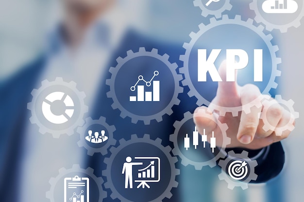 Photo a man is pointing at kpi and the word kpi on a screen