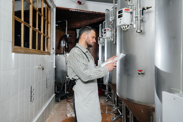 A man is preparing beer in a brewery.