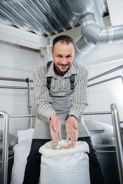 A man is preparing beer in a brewery.