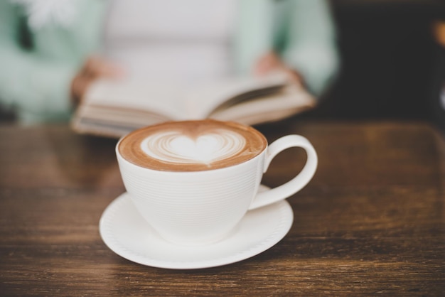 Man is reading and having coffee in the morning at cafe