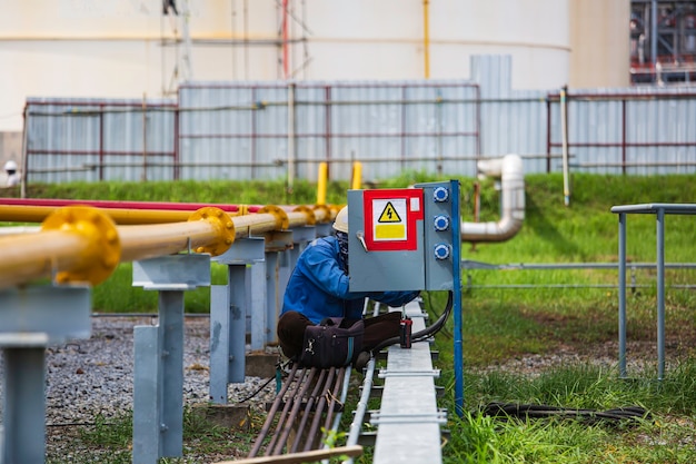 The man is repairing the switchboard highvoltage with automatic switches.