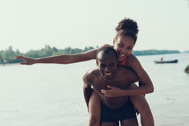 Man is Rolls Woman on His Back