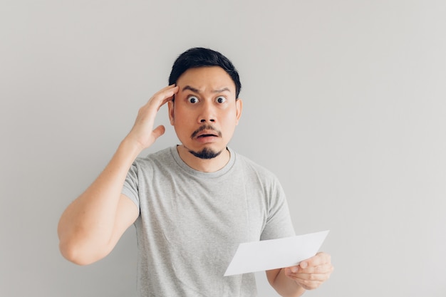 Man is shocked and surprised with the white mail message or the bill.