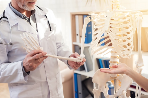 Man is Showing Skeleton Hand. Woman is Gesticulating.