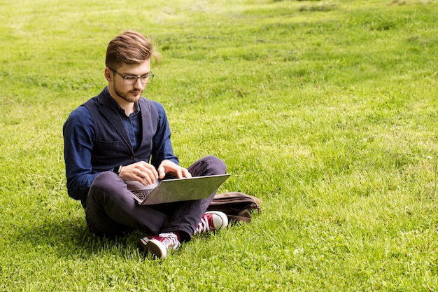 Man is sitting on a lawn