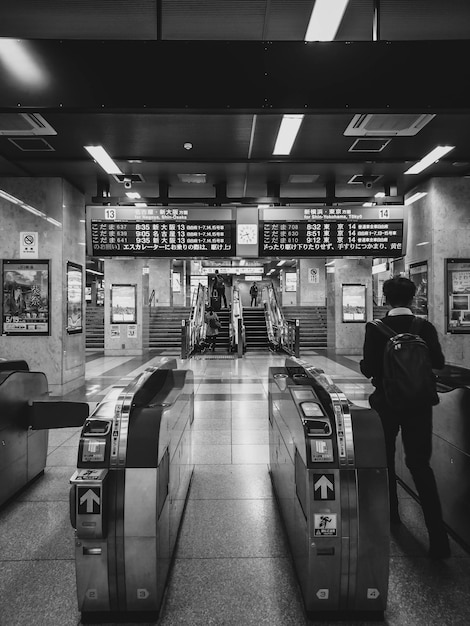 A man is standing on an escalator in a subway station.