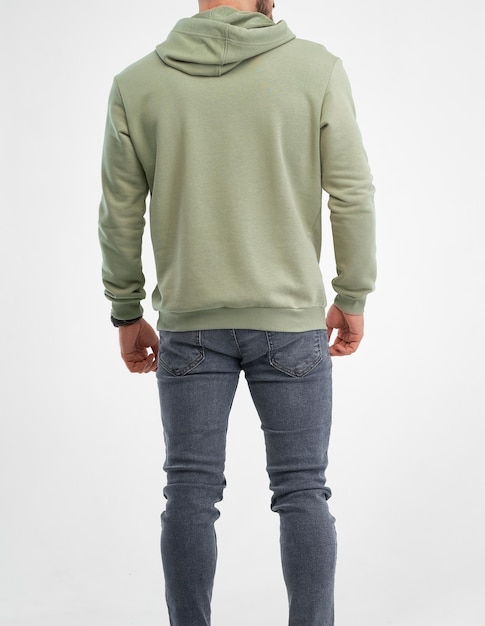 Man is standing in green hoodie isolated shot of bearded guy wears pistachio color sweatshirt with hood