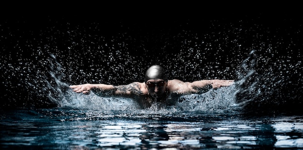 Man is swimming breaststroke. Water sports concept