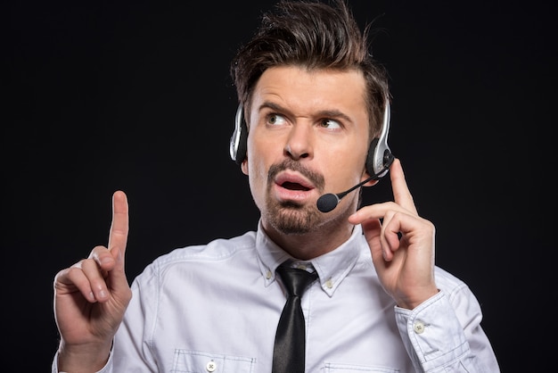 Man is talking with headphones and microphone.