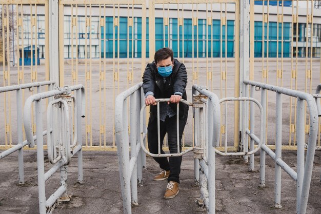 Man is trying pass through a closed fence, refugee concept, coronavirus quarantine.