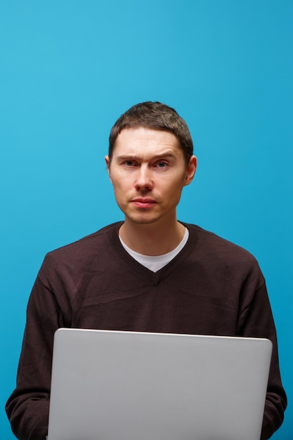 Man is using a laptop on blue background Social media concept