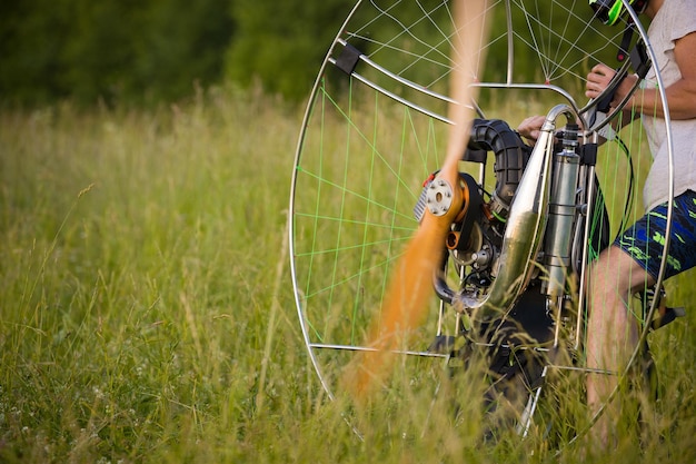 The man is warming up the engine Motorized equipment for individual paragliding flights