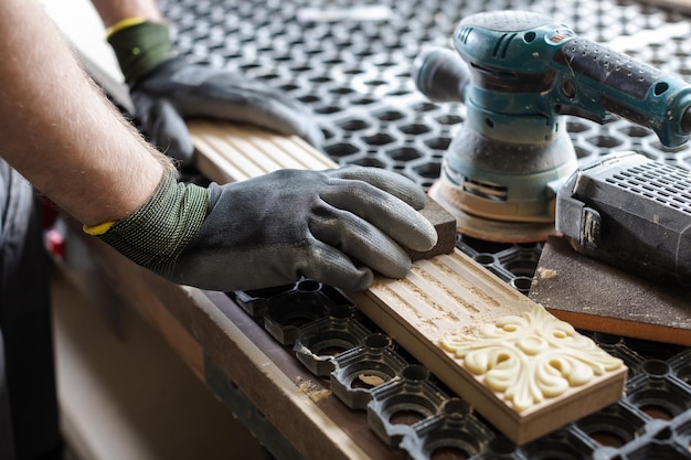 A man is working on a board with a ruler and a piece of wood