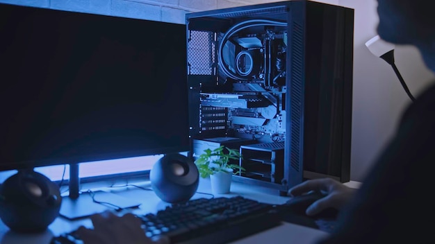 man is working at professional computer with backlight clip man is working at computer with backlight programmer or gamer with stylish computer setup