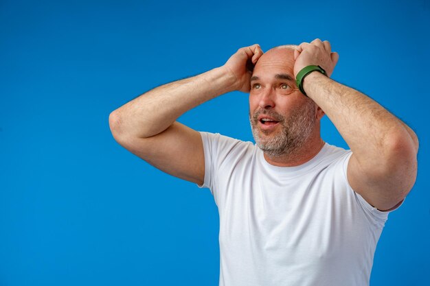 Man over isolated blue background with surprise facial expression