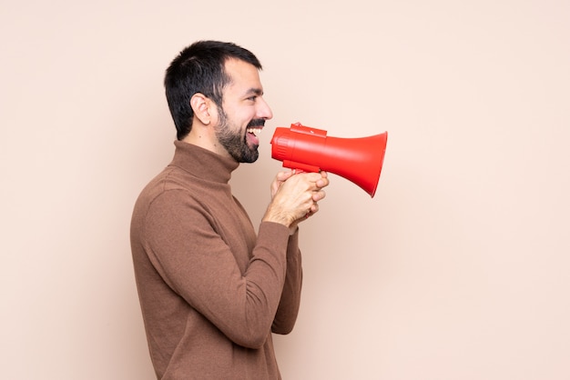 Man over isolated  shouting through a megaphone