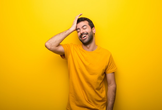 Man on isolated vibrant yellow color has just realized something and has intending the solution