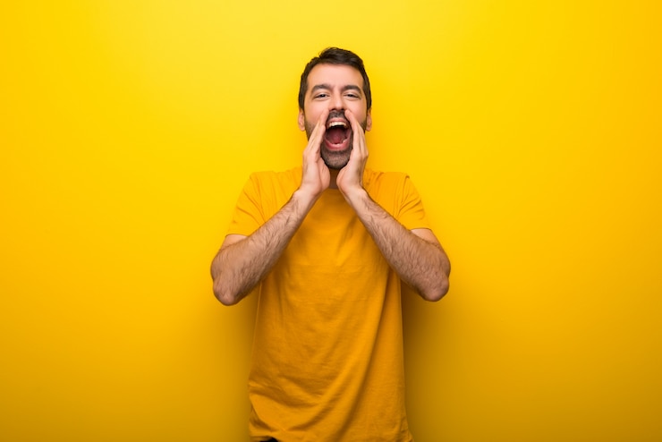 Photo man on isolated vibrant yellow color shouting and announcing something
