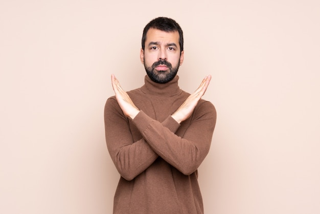 Man over isolated wall making NO gesture