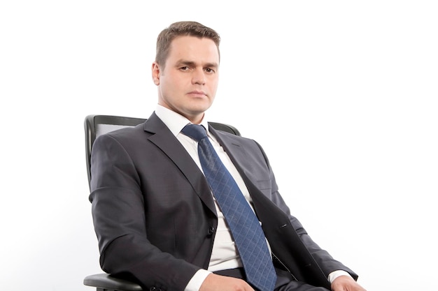 Man in a jacket sitting on a chair