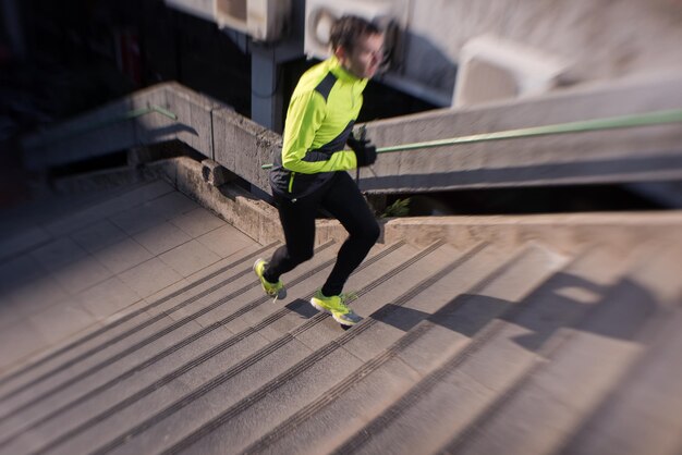 man jogging  at cold autumn  mornigng on steps