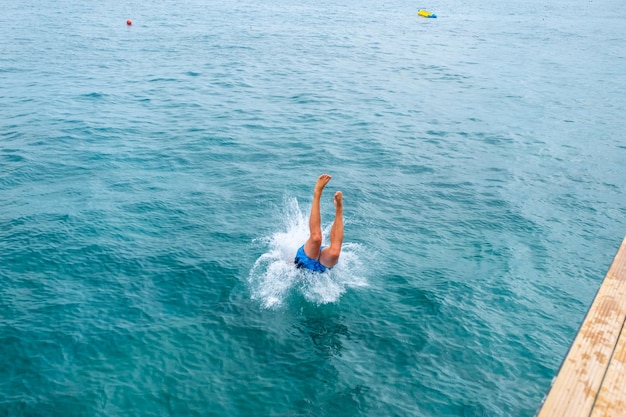 Man jumping inside the ocean