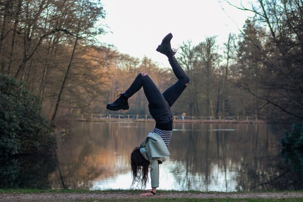 Man jumping in lake against trees