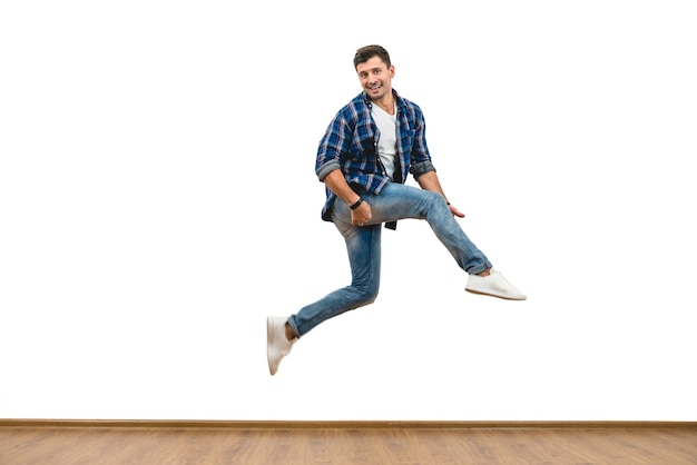 The man jumping on the white wall background